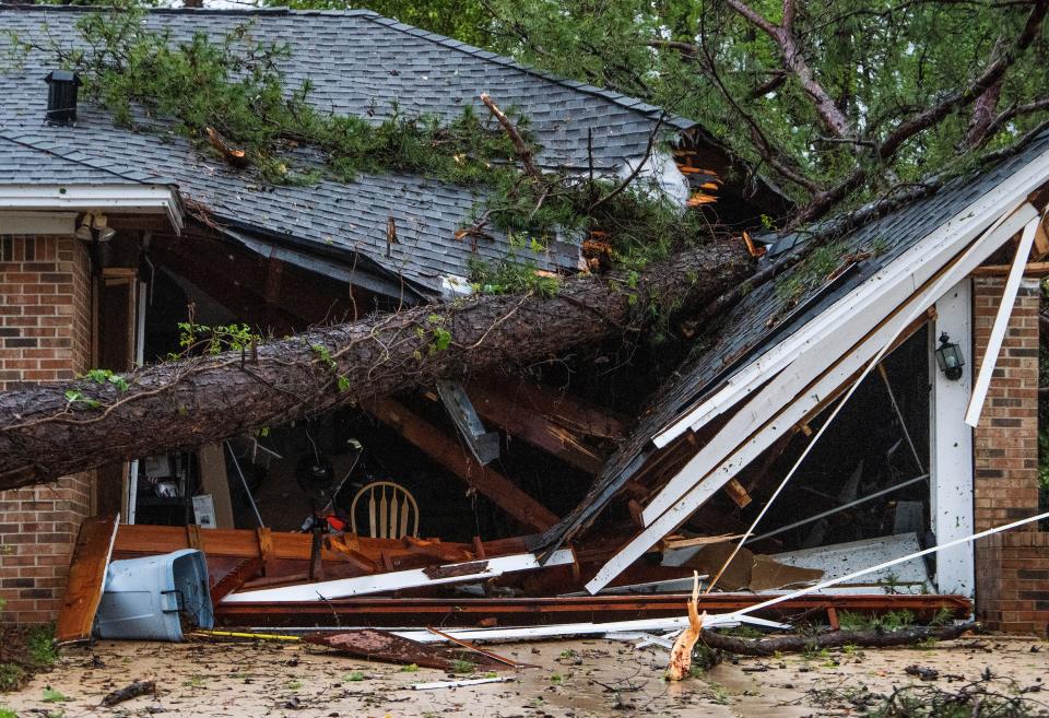 Trees are seen down on houses in the Hunting Ridge neighborhood after overnight storms hit Prattville, Ala., on Monday morning March 27, 2023.