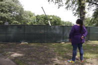 Carolyn Michael-Banks watches as workers dig up the remains of Confederate Gen. Nathan Bedford Forrest and his wife to move the bodies from Health Sciences Park June 4, 2021, in Memphis, Tenn. With the approval of relatives, the remains will be moved to the National Confederate Museum in Columbia, Tenn. (AP Photo/Karen Pulfer Focht)