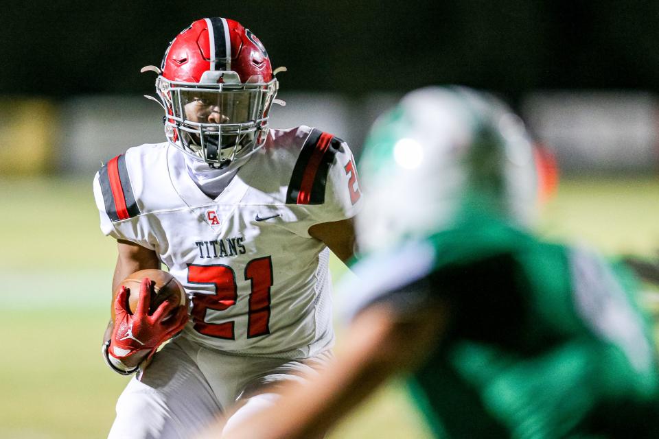 Carl Albert's Xavier Robinson runs for a touchdown during a game at Bishop McGuinness on Oct. 14.