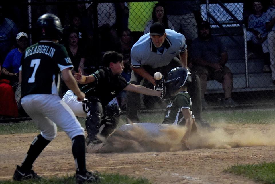 Mattingly Landscape catcher Cole Lavery misses the connection to tag out Edward Jones' Treig Loughman during the Varsity Division championship in the 77th Licking County Shrine Tournament on Thursday, June 23, 2022. Mattingly pulled out a 6-5 win in the bottom of the sixth inning against North Newark Little League rival Edward Jones at Mound City.