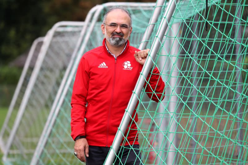 Ali Oezcan, vice-president of Swiss soccer club FC Uster poses on a pitch in Uster