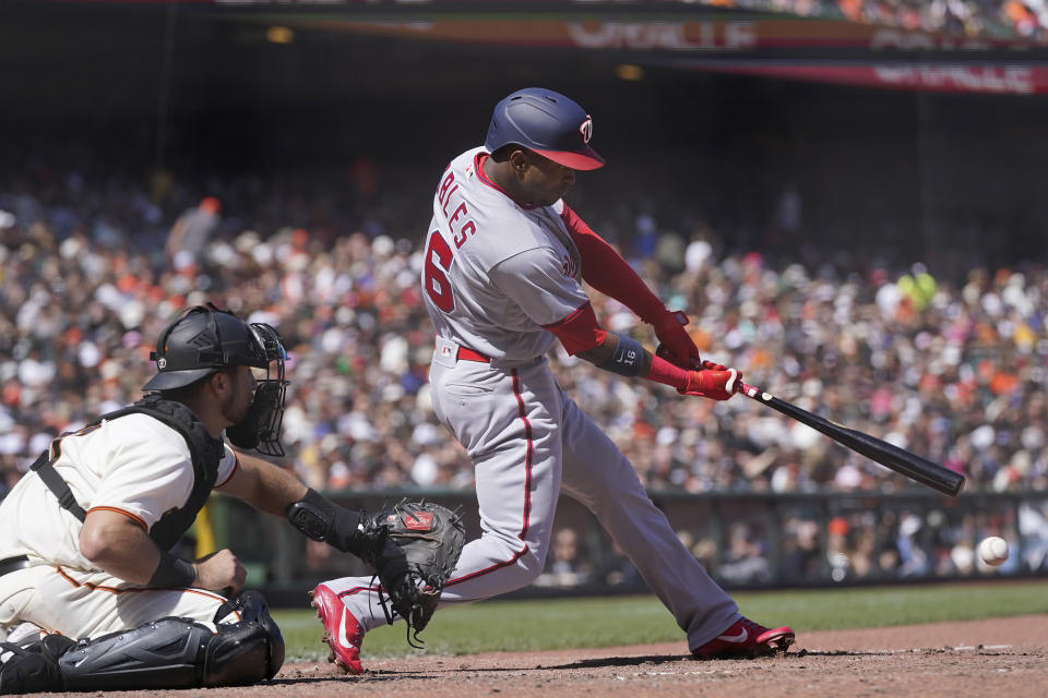 Washington Nationals' Victor Robles hits an RBI-single in front of San Francisco Giants catcher Joey Bart during the seventh inning of a baseball game in San Francisco, Sunday, May 1, 2022. (AP Photo/Jeff Chiu)