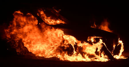 A car is engulfed in flames during the Woosley Fire in Malibu, California, U.S. November 9, 2018. REUTERS/Gene Blevins