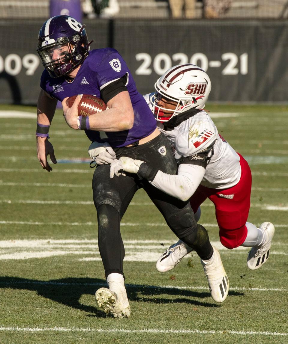 Holy Cross quarterback Matthew Sluka runs the ball for a first down against Sacred Heart University.