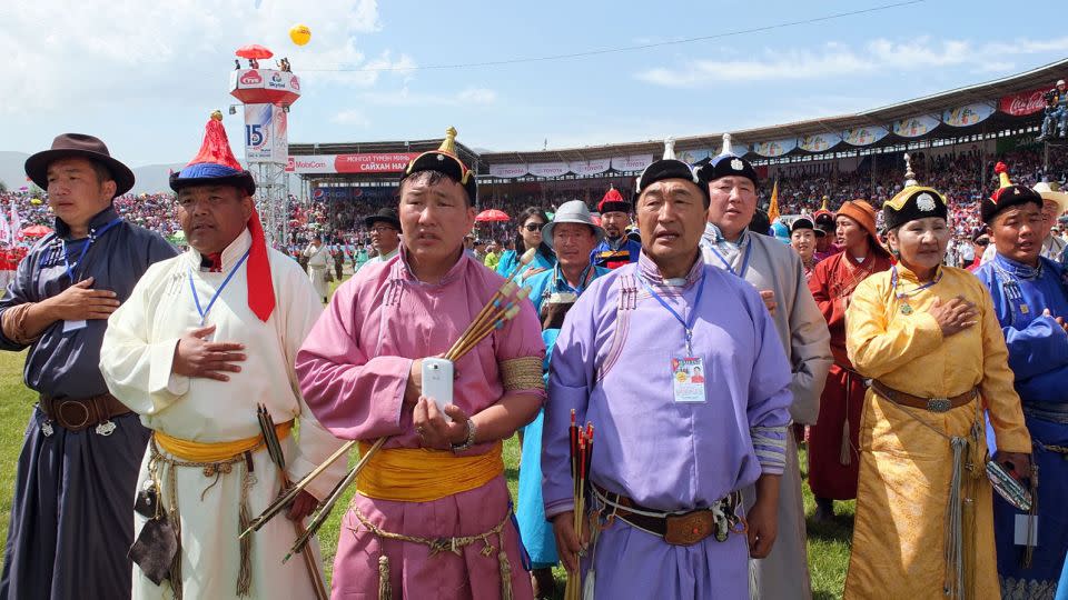 Archery players sing the national anthem during the 2014 Naadam opening ceremony in Ulaanbaatar. - Kyodo/AP