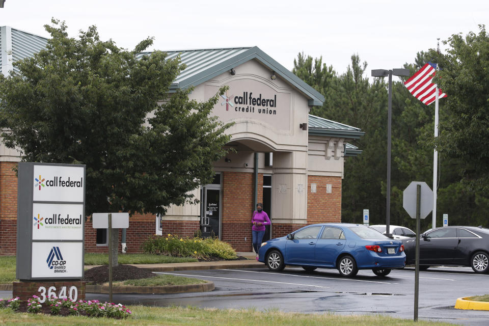 A customer walks out of the Call Federal Credit Union building Tuesday, June 16, 2020, in Midlothian, Va. Police were able to obtain geofence search warrants, a tool being increasingly used by law enforcement. The warrant sought location histories kept by Google of cellphones and other devices used within 150 meters (500 feet) of the bank. (AP Photo/Steve Helber)