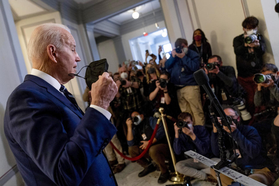 President Joe Biden takes off his mask to speak to members of the media as he leaves a meeting with the Senate Democratic Caucus to discuss voting rights and election integrity on Capitol Hill in Washington, Thursday, Jan. 13, 2022. (AP Photo/Andrew Harnik)