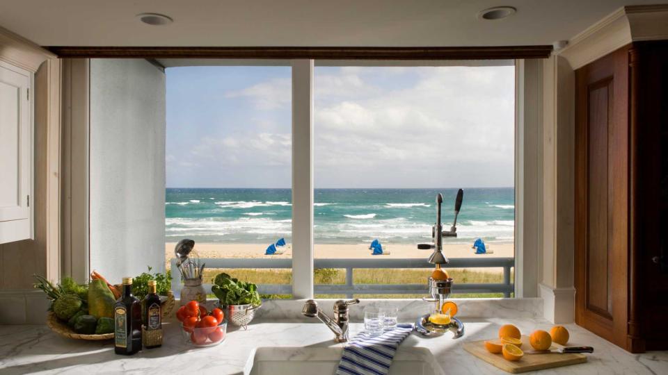 A kitchen counter with a view of the Atlantic Ocean and beachfront from a condo residence in Boca Raton, FL.