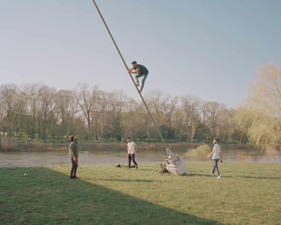 Young men fool around on the banks of the river Weser in Minden on April 8. In most federal states in Germany people are allowed to move freely, while keeping a distance of at least five feet from others. | Ingmar Björn Nolting—DOCKS Collective