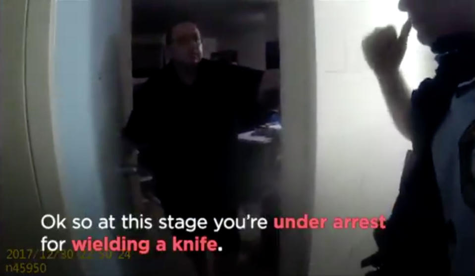 An officer informs Mr Dwyer he’s under arrest for wielding a knife in the apartment complex. Source: 7 News