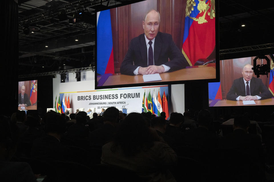 Russian President Vladimir Putin addresses leaders from the BRICS group of emerging economies at the start of a three-day summit in Johannesburg, South Africa , Tuesday, Aug. 22, 2023. Putin appeared on a video link after his travel to South Africa was complicated by an International Criminal Court arrest warrant against him over the war in Ukraine. (AP Photo/Jerome Delay)