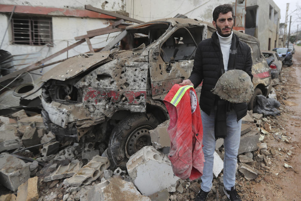 A man carries belongings of a paramedic killed at a paramedic center the was hit by an Israeli airstrike early Wednesday in Hebbariye village, south Lebanon, Wednesday, March 27, 2024. The Israeli airstrike on a paramedic center linked to a Lebanese Sunni Muslim group killed several people of its members. The strike was one of the deadliest single attacks since violence erupted along the Lebanon-Israel border more than five months ago. (AP Photo/Mohammed Zaatari)