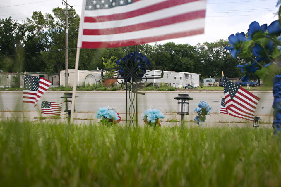 A memorial begins to take shape, Saturday, July 15, 2023, in Fargo, N.D., where one police officer was fatally shot and two others were critically wounded a day earlier. Authorities have said the suspect was also killed in the shooting, and a civilian was injured. (AP Photo/Ann Arbor Miller )