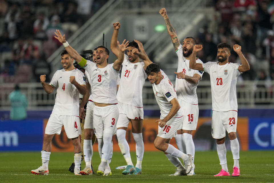 Iran players celebrate during the penalty shootout during the Asian Cup Round of 16 soccer match between Iran and Syria, at Abdullah Bin Khalifa Stadium in Doha, Qatar, Wednesday, Jan. 31, 2024. (AP Photo/Aijaz Rahi)