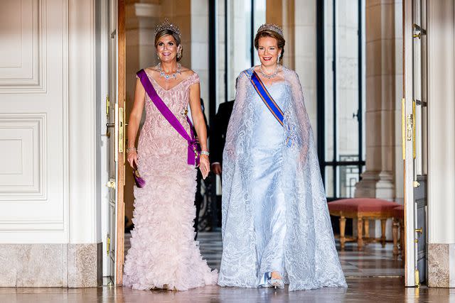 <p>Patrick van Katwijk/Getty </p> Queen Mathilde of Belgium and Queen Maxima of The Netherlands during the state banquet at Laeken Castle on June 20.