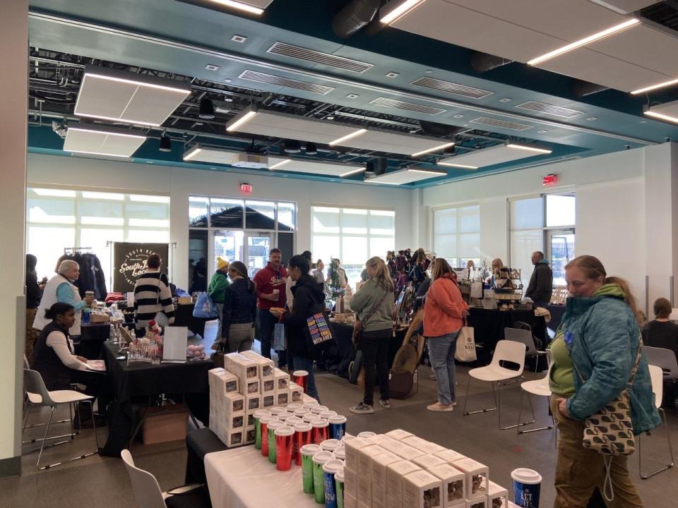 Shoppers visit booths at the Howard Holiday Market on Small Business Saturday on November 26, 2022, at the Howard Park Event Center in South Bend.