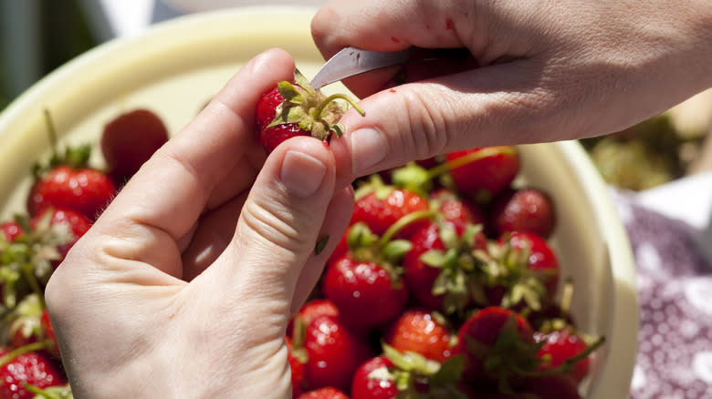 Hulling strawberries with paring knife