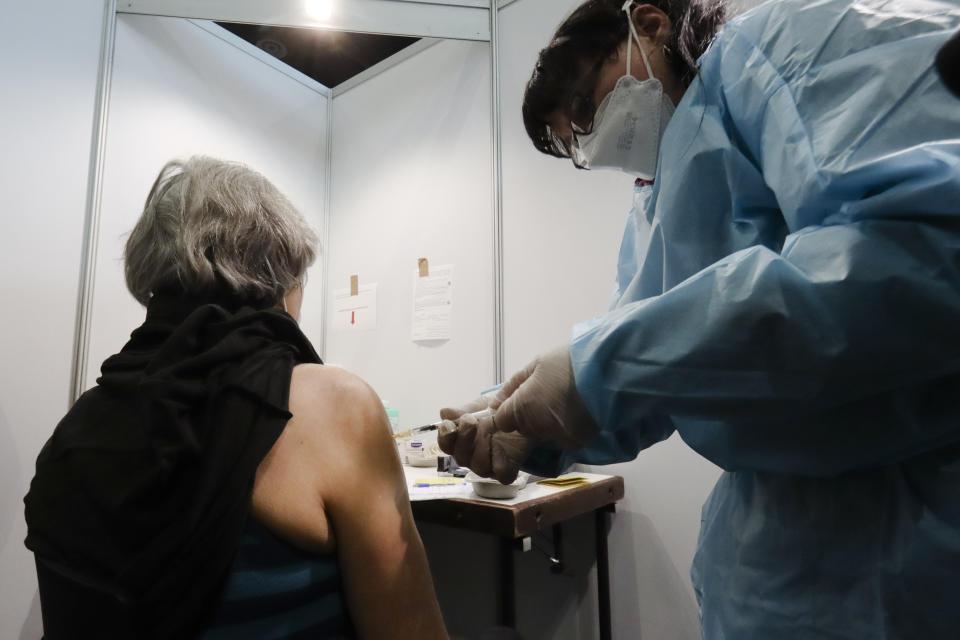 A Holocaust survivor receives a injection of the Pfizer/BioNTech vaccine against the COVID-19 disease, at a a vaccination center in Vienna, Austria, Wednesday, Jan. 27, 2021. Hundreds of Holocaust survivors in Austria and Slovakia are getting vaccinated against the coronavirus exactly 76 years after the liberation of the Nazi's Auschwitz death camp. More than 400 Austrian survivors were invited to get the vaccine at Vienna's biggest mass vaccination center on International Holocaust Remembrance Day on Wednesday Jan. 27, 2021. (AP Photo/Ronald Zak)