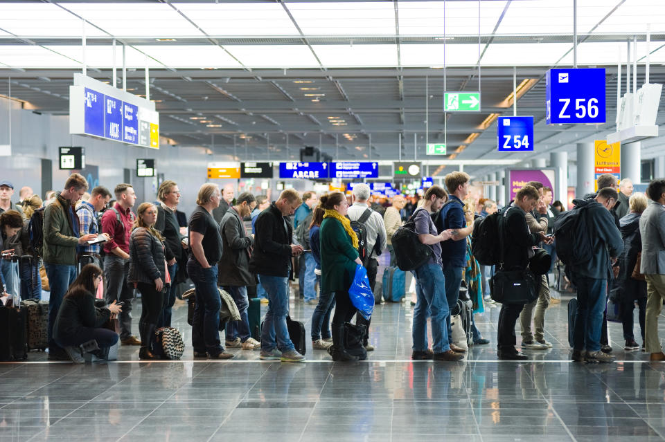 Frankfurt, Germany - April 25, 2016: Passengers waiting in a row for boarding on an airport to a flight to America