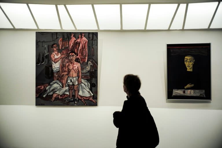 A woman looks at Zeng Fanzhi's "Meat" (1992)