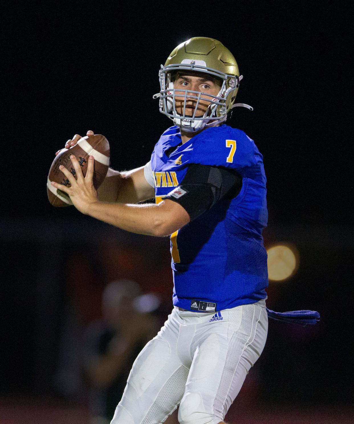 Cardinal Newman quarterback Luke Warnock looks for an open receiver against Benjamin during their football game on October 20, 2023 in West Palm Beach, Florida.