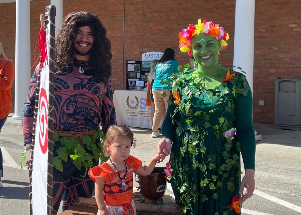 Alex Vigil, Savannah Vigil, 18 months, and Brooke Vigil won best group costume for their interpretation of “Moana” characters at the third annual Farragut Harvest Festival at Village Green Shopping Center, Oct. 22, 2023.