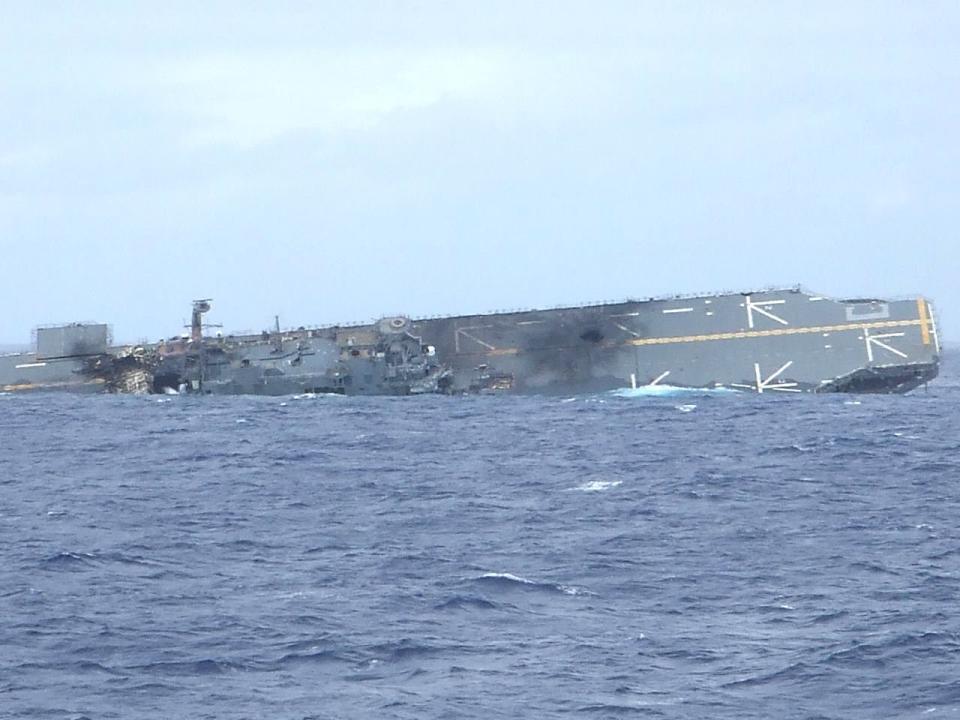 The ex-USS <em>Belleau Wood</em> seen on its side during the 2006 RIMPAC SINKEX. <em>Ste Elmore via Wikimedia</em>