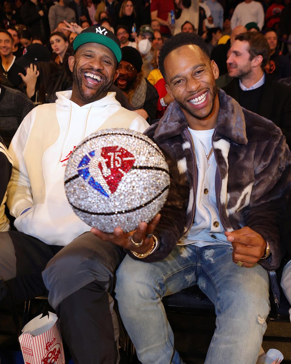 Victor Cruz (with former Yankee C.C. Sabathia) hoists the sparkly ball.