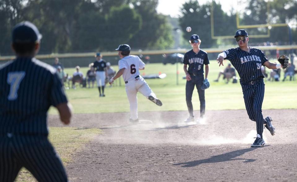 Central Catholic’s Adrian Garcia, right, throws out a runner during the Northern California Regional Division III semifinal playoff game with Arcata at Central Catholic High School in Modesto, Calif., Thursday, June 1, 2023.