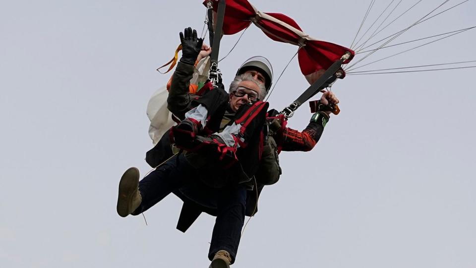 Texas Gov. Greg Abbott skydives in tandem, Nov. 27, 2023, in Fentress, Texas. Abbott was invited to jump by 106-year-old World War II veteran Al Blaschke. (Eric Gay/AP)