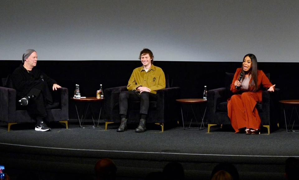 Ryan and Evan reacting as Niecy speaks onstage