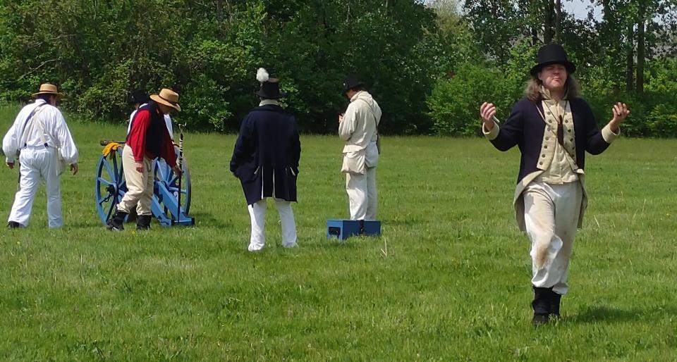 A War of 1812 re-enactor motions during drills at the River Raisin National Battlefield Park.