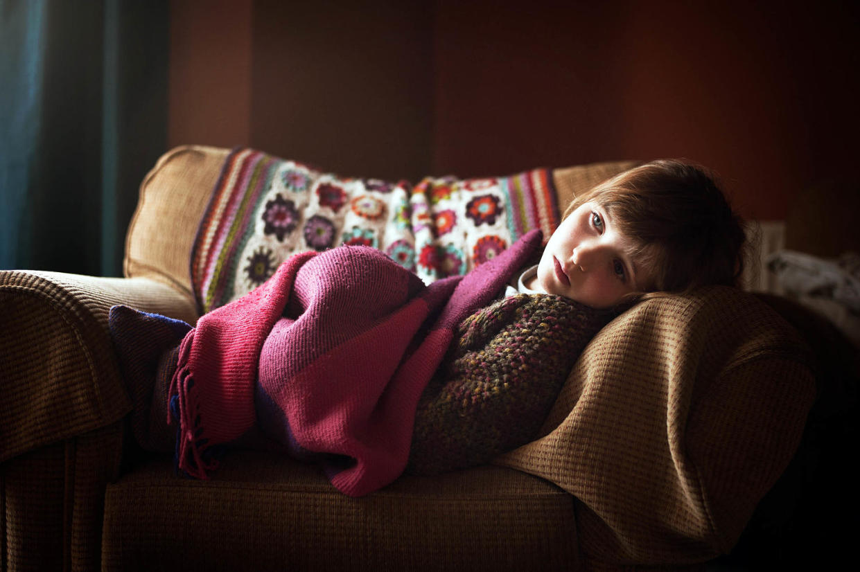 Girl on couch (Deborah Faulkner / Getty Images)