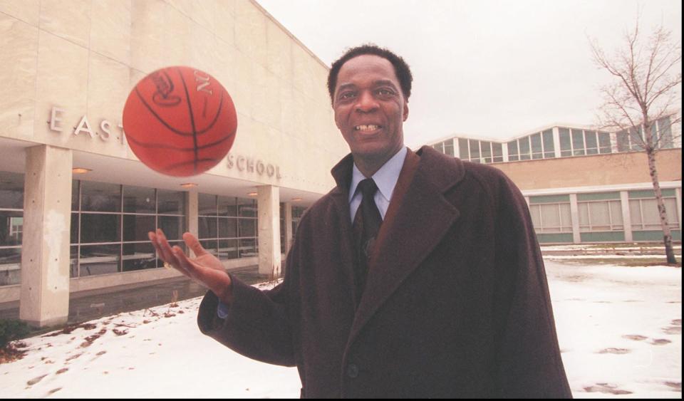 Al Butler stands outside his alma mater, East High School, in 1996.