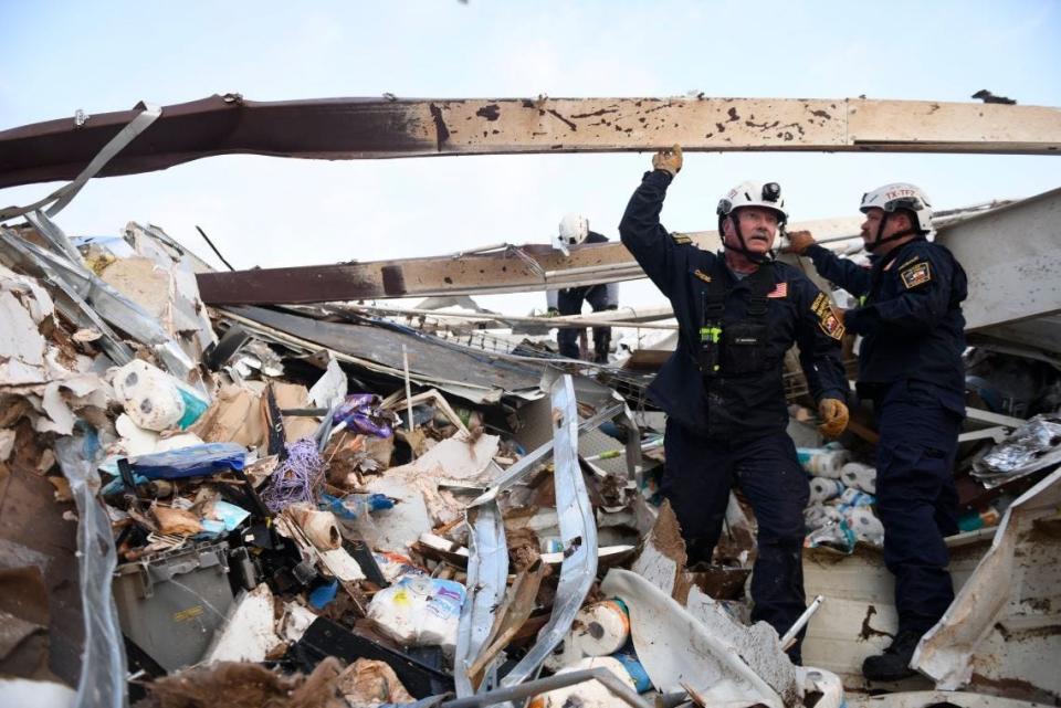 Emergency crew members search through debris the morning after a tornado passed through the community of Matador, leaving multiple people dead Wednesday evening, June 21, on the Texas Rolling Plains.