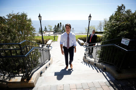 Canada's Prime Minister Justin Trudeau walks outside the Manoir Richelieu, site of the upcoming G7 leaders' summit in Quebec's Charlevoix region, before the start of an interview with Reuters in La Malbaie, Quebec, Canada, May 24, 2018. REUTERS/Chris Wattie