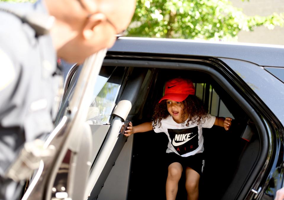 Donald Jackson, 3, of Canton checks out a police car during this year's first We Believe in Canton community event, which was held Wednesday at Centennial Plaza in Canton.