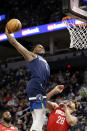 Minnesota Timberwolves forward Anthony Edwards (1) dunks over Houston Rockets center Alperen Sengun (28) during the first half of an NBA basketball game Wednesday, Oct. 20, 2021, in Minneapolis. (AP Photo/Andy Clayton-King)