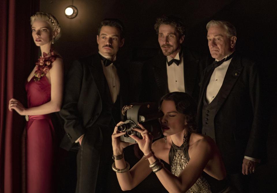 This image released by 20th Century Studios shows, clockwise from left, Anya Taylor-Joy, Rami Malek, Christian Bale, Robert De Niro and Margot Robbie in a scene from "Amsterdam." (Merie Weismiller Wallace/20th Century Studios via AP)