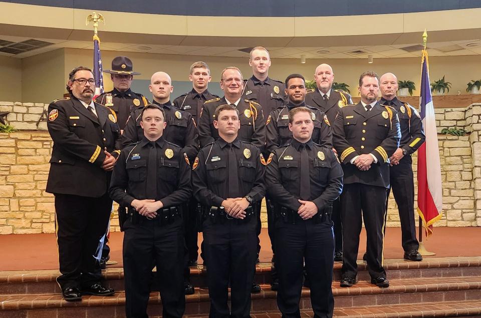 Graduates of the 101st Amarillo Police Academy stand with staff and the APD chief Thursday at the Amarillo Civic Center.