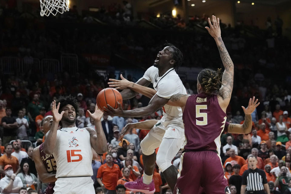 Florida State forward De'Ante Green (5) defends Miami guard Bensley Joseph (4) as he drives to the basket during the second half of an NCAA college basketball game, Saturday, Feb. 25, 2023, in Coral Gables, Fla. (AP Photo/Marta Lavandier)