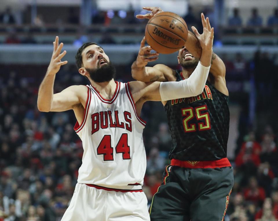 FILE - In this Wednesday, Jan. 25, 2017, file photo, Chicago Bulls forward Nikola Mirotic (44) fouls Atlanta Hawks forward Thabo Sefolosha (25) during the first half of an NBA basketball game in Chicago. Teams, and the league, try to make the transition to the NBA easier for all players, but internationals need some special attention. Mirotic said international players, even those from different countries, tend to stick together on the road. They go to movies and dinners together because they often have similar interests. (AP Photo/Kamil Krzaczynski, File)