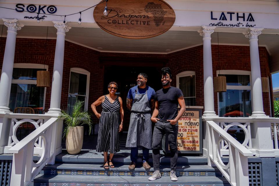 Digby Stridiron, chef and co-owner at Latha Restaurant & Bar, center, owner Evelia Davis, left, and General Manager Will Brazil, right, pose for a portrait at the restaurant located within the Diaspora Collective in Phoenix on April 19, 2023.