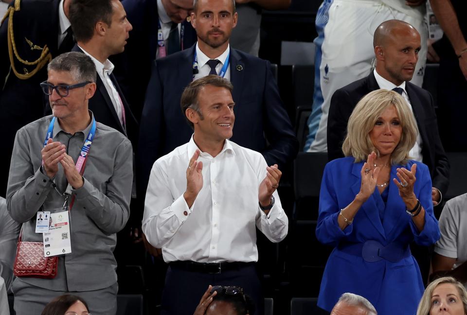 French President Emmanuel Macron and wife Brigitte Macron 
in a sapphire blue suit attend the Women's Gold Medal game between Team France and Team United States on day sixteen of the Olympic Games Paris 2024 at Bercy Arena on Aug. 11.