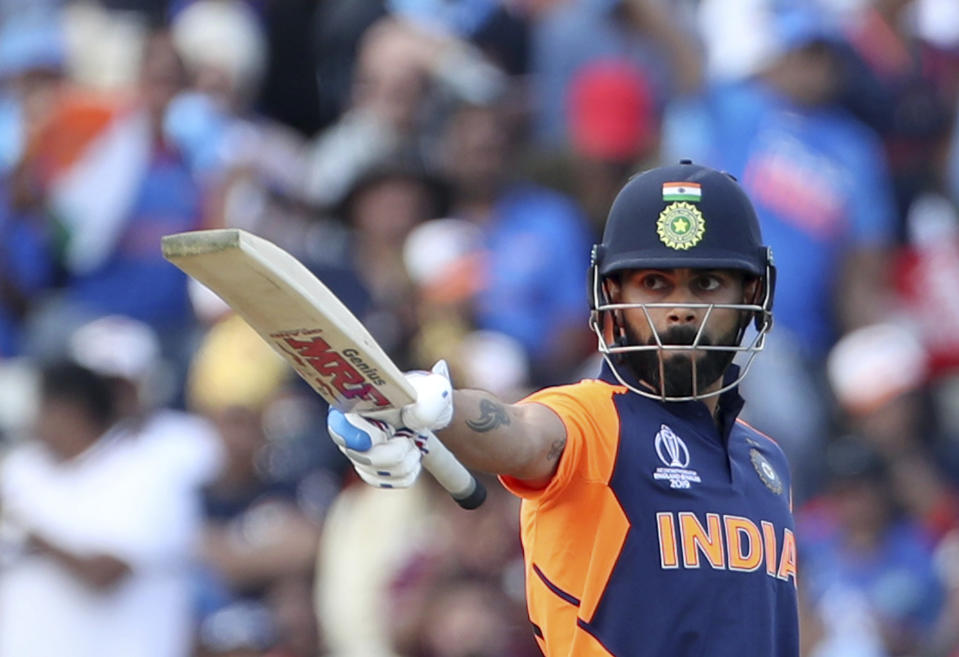 India's captain Virat Kohli raises his bat to celebrate scoring fifty runs during the Cricket World Cup match between England and India at Edgbaston in Birmingham, England, Sunday, June 30, 2019. (AP Photo/Aijaz Rahi)