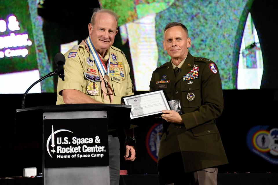 Lt. Gen. Daniel L. Karbler, U.S. Army Space and Missile Defense Command commanding general, receives a certificate of appreciation from Jim Charlton, assistant council commissioner of the Greater Alabama Council, Boy Scouts of America, during the council’s 25th anniversary banquet at the Davidson Center for Space Exploration on Nov. 11, 2023.