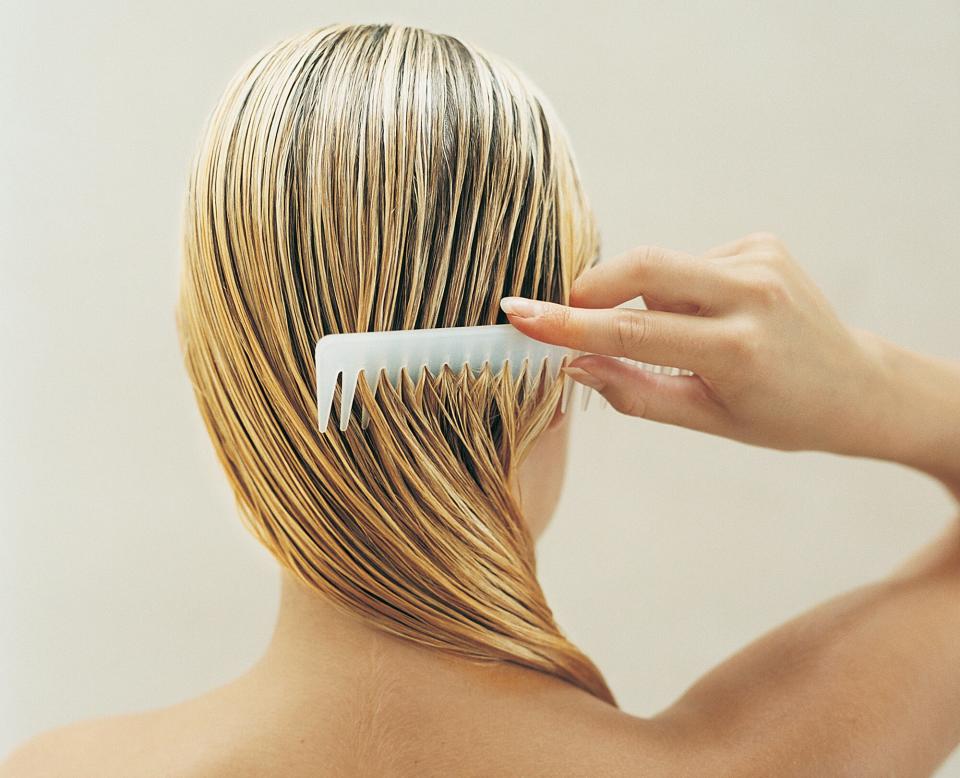 Woman combing her hair