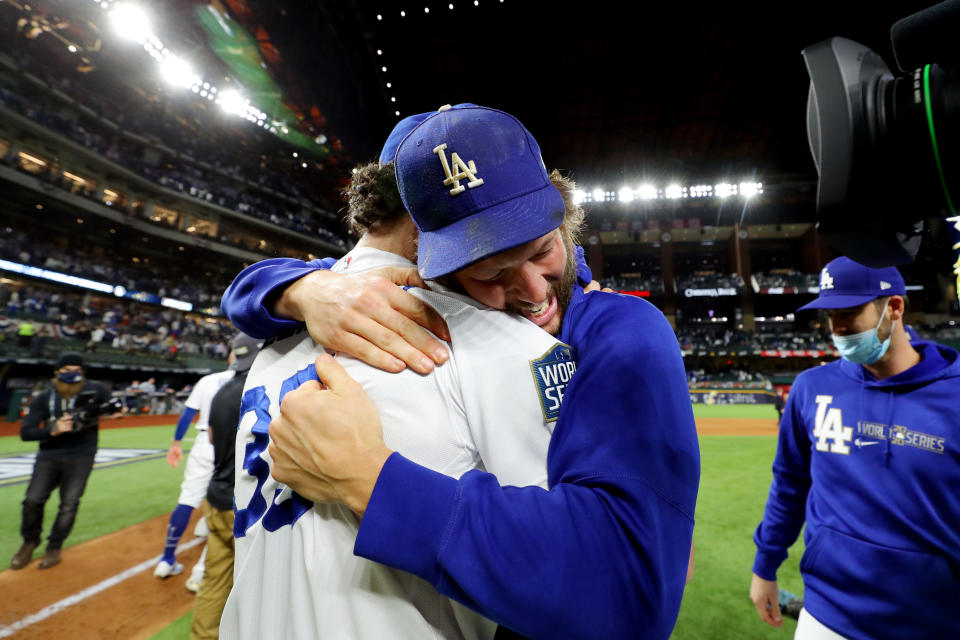 ARLINGTON, TX - OCTOBER 27:  Clayton Kershaw #22 and Cody Bellinger #35 of the Los Angeles Dodgers celebrate on the field after defeating the Tampa Bay Rays in Game 6 to clinch the 2020 World Series at Globe Life Field on Tuesday, October 27, 2020 in Arlington, Texas. (Photo by Alex Trautwig/MLB Photos via Getty Images)