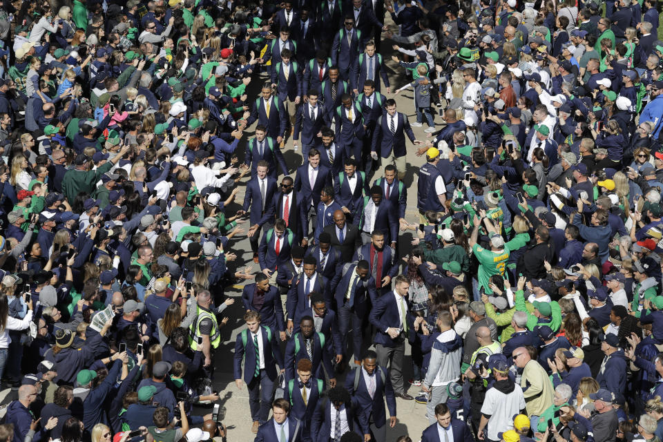 FILE - In this Oct. 5, 2019, file photo, Notre Dame players greet fans as they enter the stadium before an NCAA college football game against Bowling Green, in South Bend, Ind. In a quirk this season, No. 5 Notre Dame enjoys a greater home-field advantage than most of its opponents: As of now, the Fighting Irish are slated to play in front of only one crowd bigger than their own, which is limited to about 10,000 people because of the pandemic. (AP Photo/Darron Cummings, File)