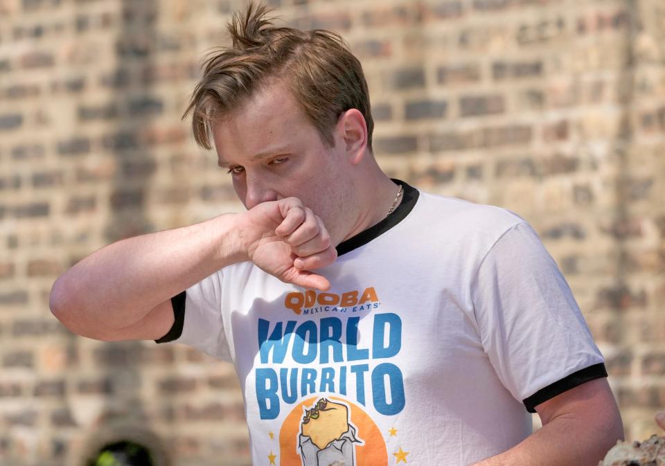 Peter Klepacz of Milwaukee takes a break while scarfing burritos Thursday during the World Burrito Eating Contest in the Deer District in Milwaukee.